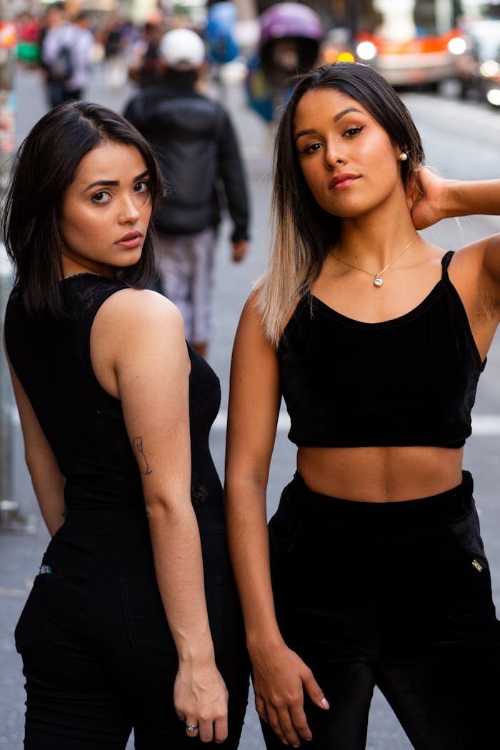 Stylish young women posing in the bustling streets of São Paulo, showcasing urban fashion.