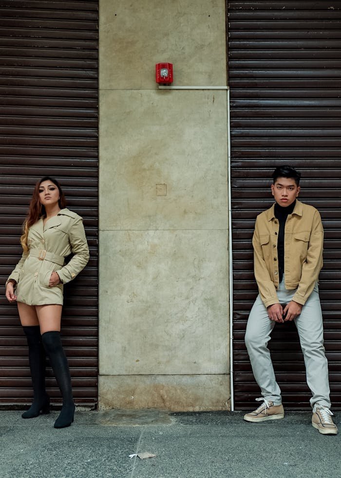 Stylish young adults posing in urban street fashion against a city backdrop.